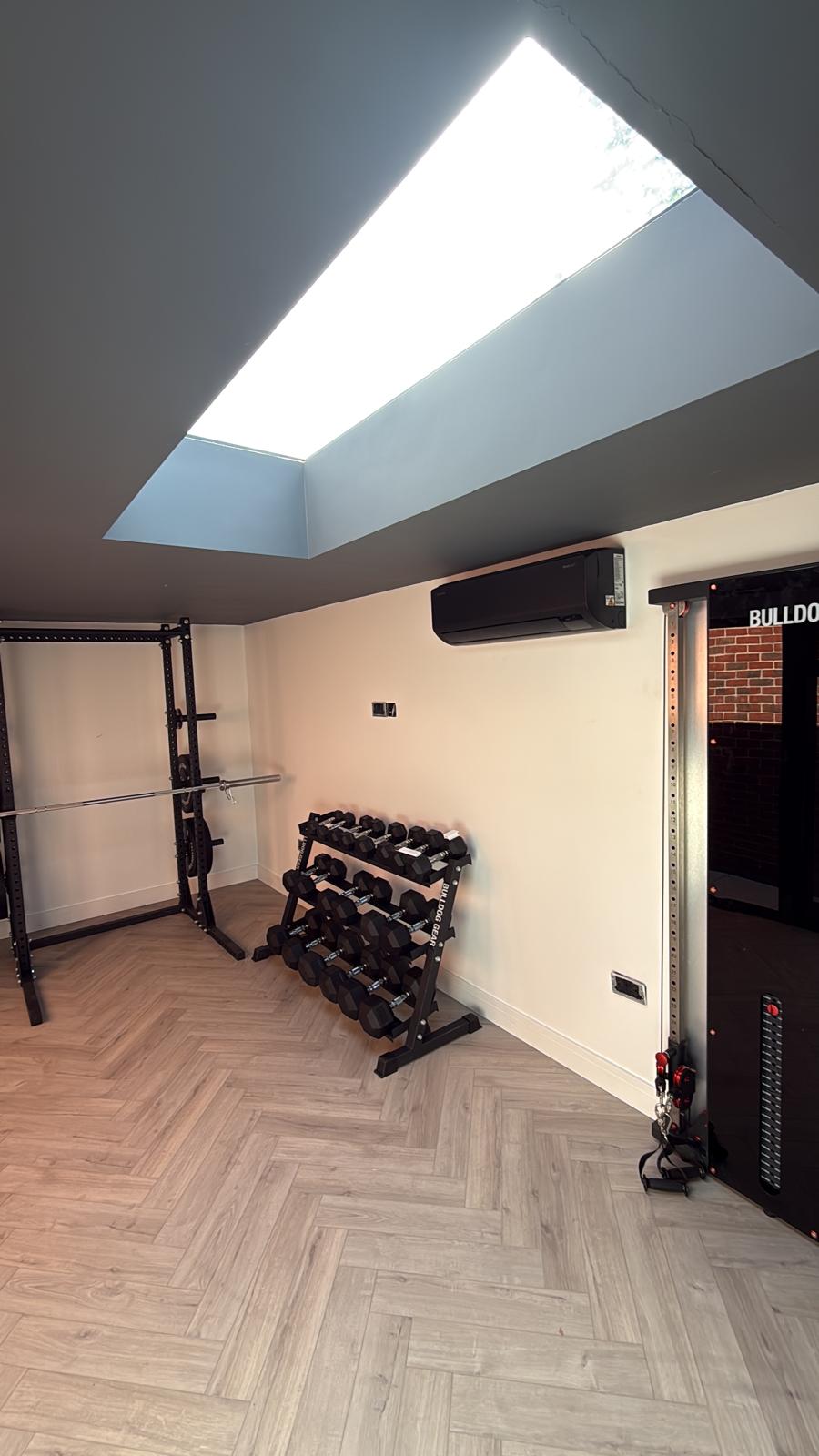 Air conditioning unit installed in a home gym with skylight